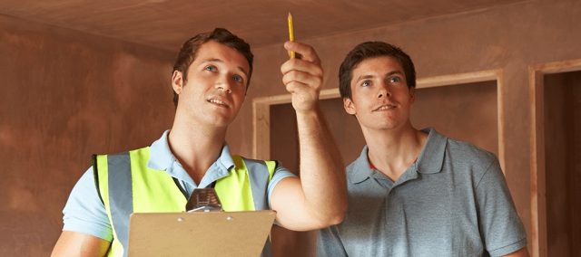 two men inspecting home